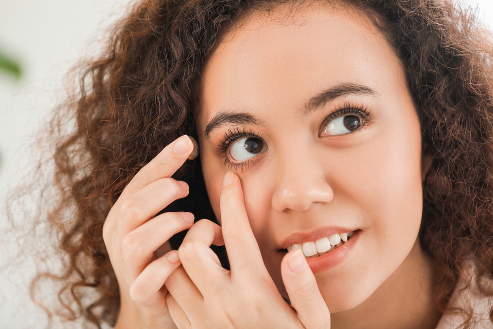 Patient adjusting a scleral contact lens designed for comfortable all-day wear