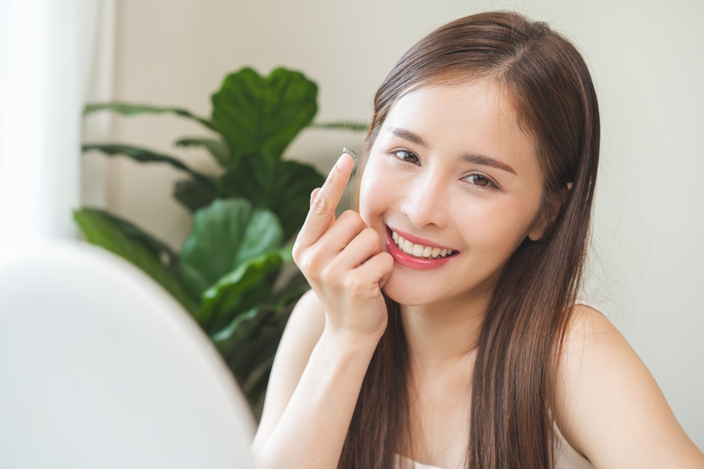 Woman preparing to insert a scleral contact lens for improved vision and eye comfort