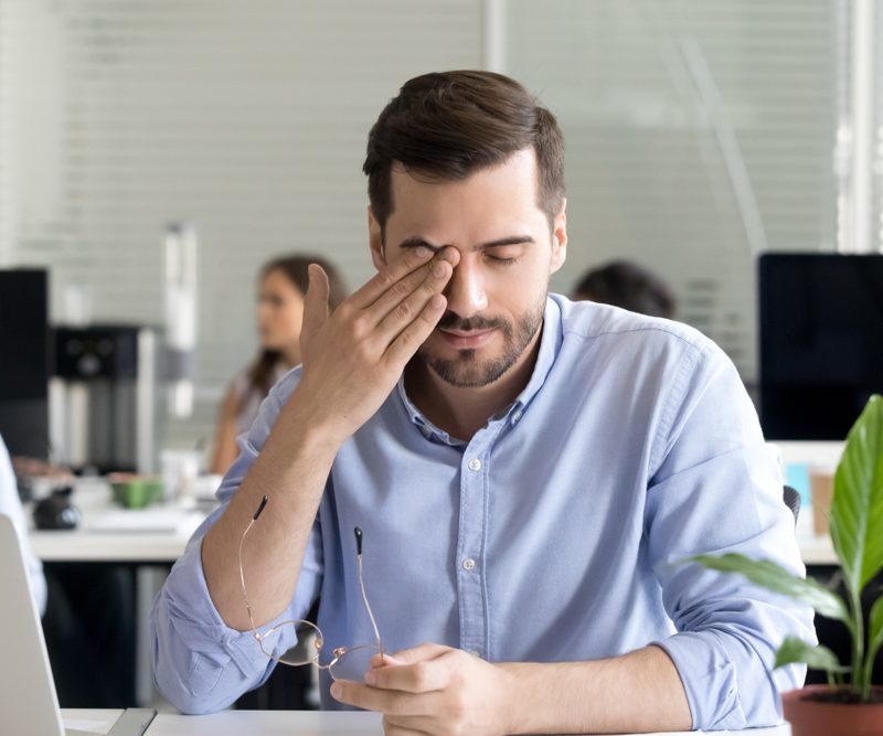Man experiencing eye discomfort associated with photokeratitis at work in Hilton Head Island and Bluffton, SC