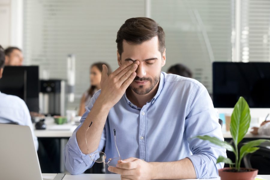 Man experiencing eye discomfort associated with photokeratitis at work in Hilton Head Island and Bluffton, SC