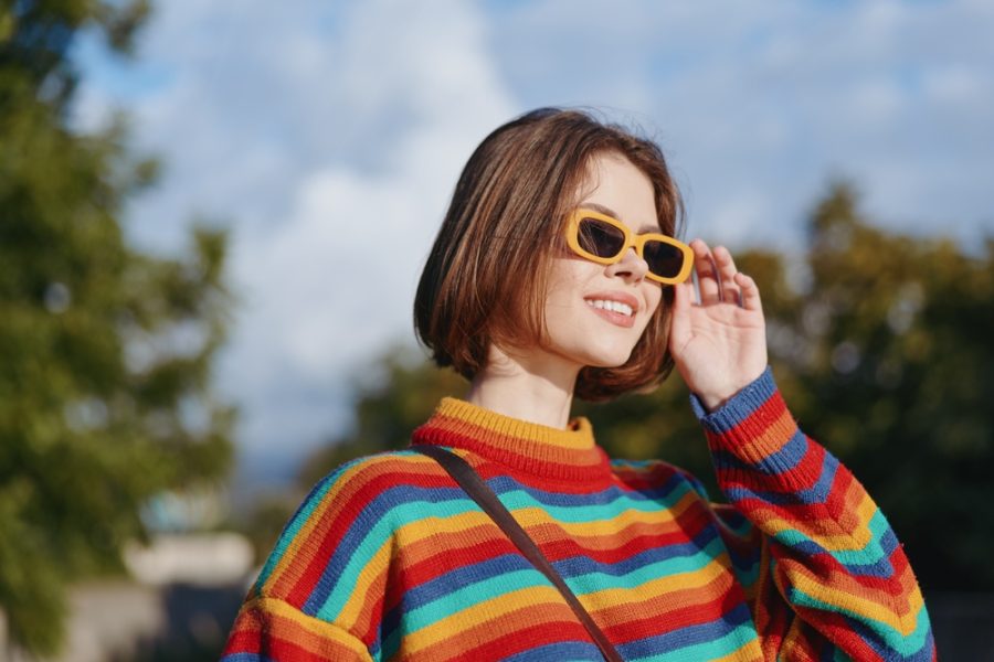 Woman wearing sunglasses outdoors to help protect against photokeratitis caused by UV exposure
