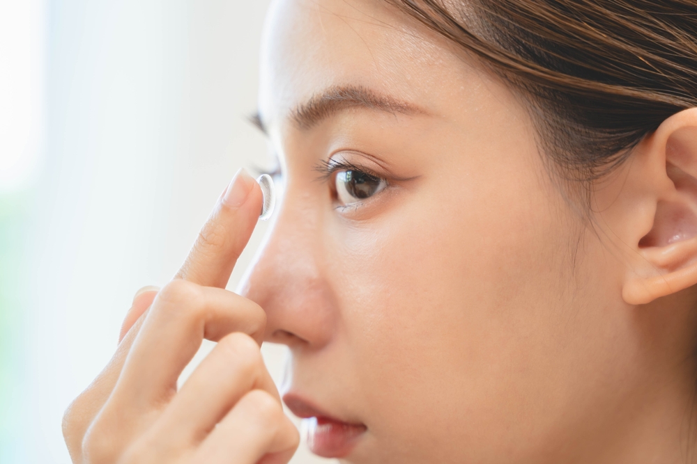 Close-up of a patient inserting a scleral lens for advanced vision correction
